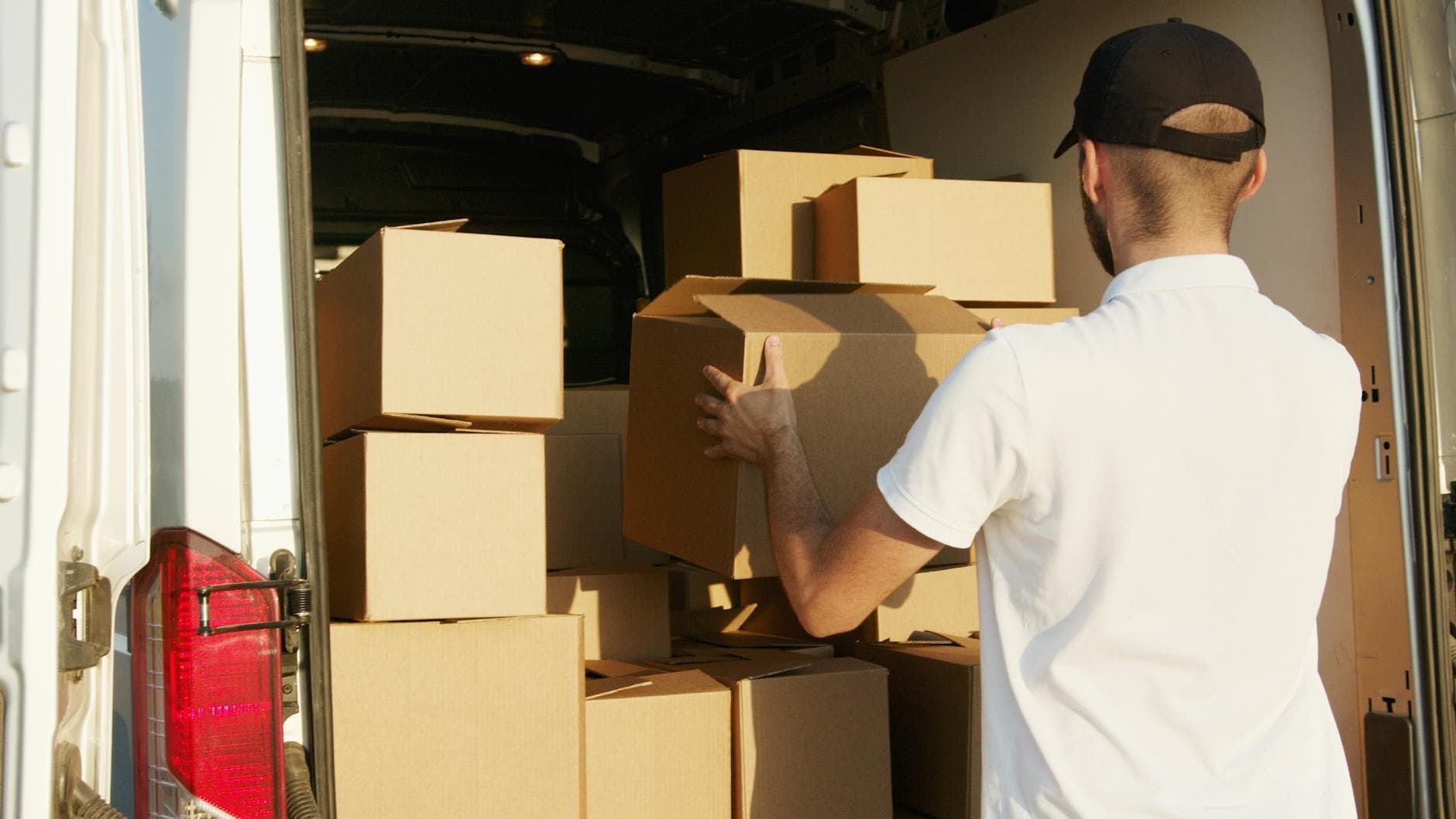 Professional movers loading boxes into a truck